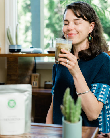 Woman enjoying a iced hojicha latte