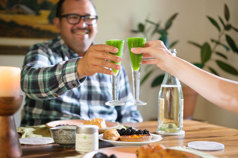 Couple toasting with matcha green tea mimosas