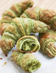Matcha Croissants with one cut in half to show layers