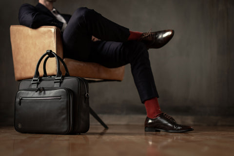 black briefcase next to man in suit