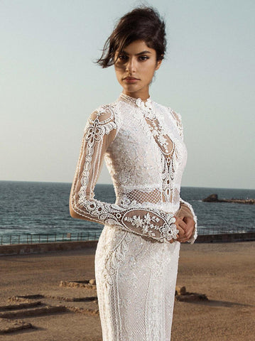 " A breathtaking Galia Lahav wedding gown featuring intricate lace detailing, a long train, and a dramatic silhouette, exemplifying timeless elegance."