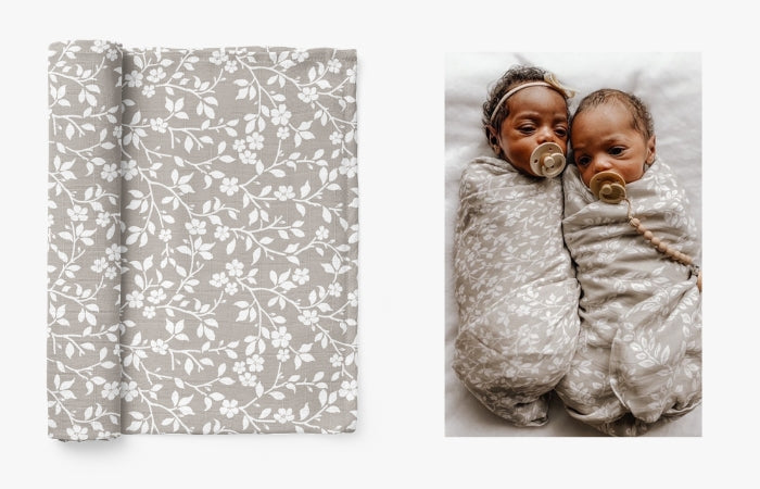 babies wrapped in gray neutral floral baby wraps