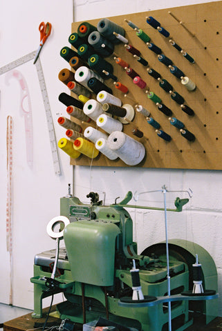A pinboard full of thread and habedashery and our highly coveted Reece 101 Buttonhole Machine