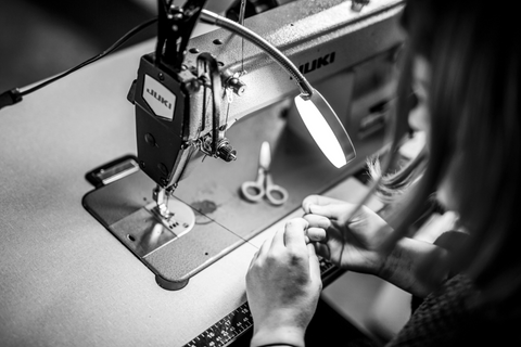 close up of Siobhan sewing some reclaimed denim