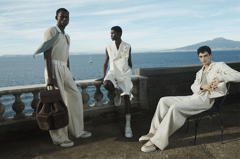 Amiri Spring Summer 24 campaign shot. Key looks include Amiri White MA Tassel Hybrid Loafers, Cream Waffle Stitch Polo T-Shirt and Double-Pleated Trousers