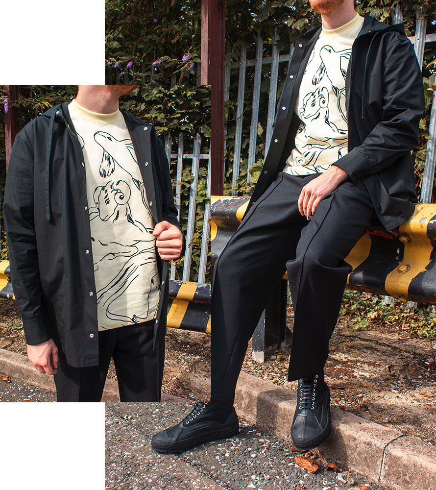 Jil Sander Outfit - Black Hooded Shirt, Beige Horoscope Graphic T-Shirt, Black Tailored Trousers, Black High Top Trainers
