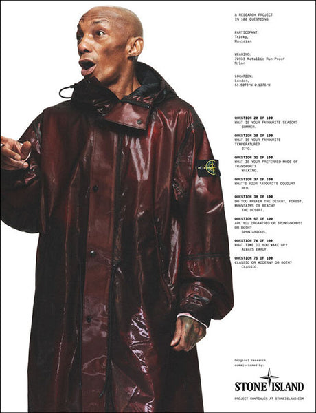 Stone Island Rust red long parka jacket. METALLIC RUN-PROOF NYLON: Long parka made of a light black polyester run-proof fabric bonded to a coloured extruded polyurethane, with a shiny metallic effect.