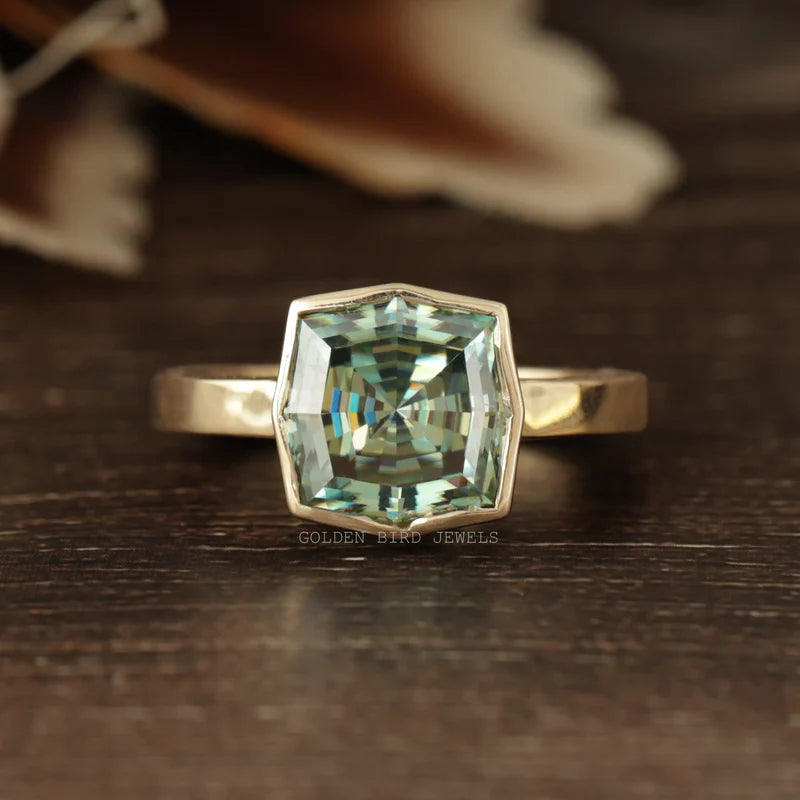 Step cut cushion moissanite ring in bezel prong setting with yellow gold