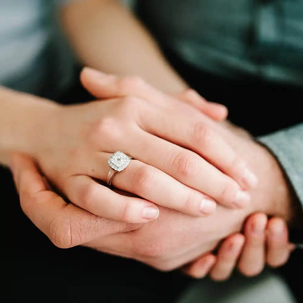 Diamond ring on the woman's hand that has been offered by a man