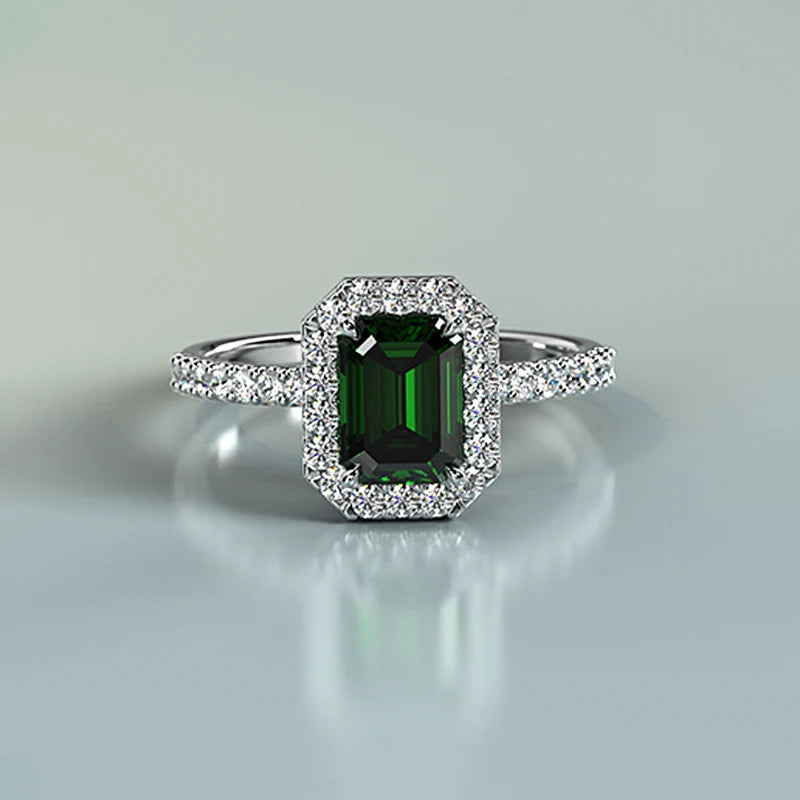 Emerald cut gemstone halo ring with diamonds and gold band