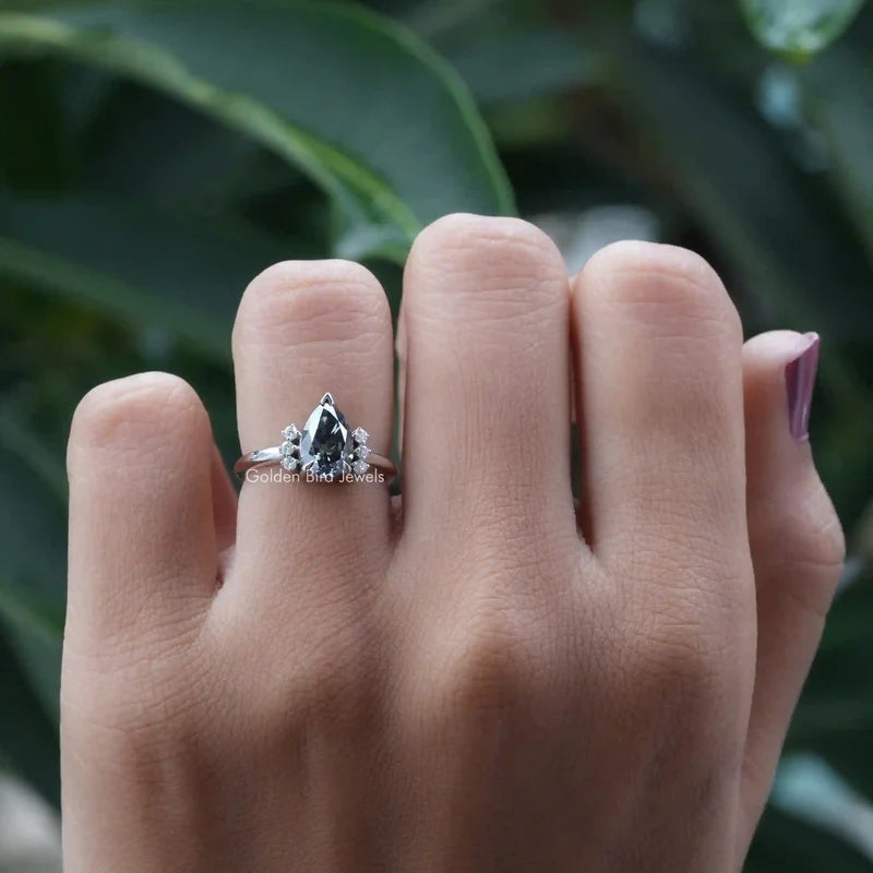 Dark fancy grey colored pear cut cluster engagement ring in white gold tapered band