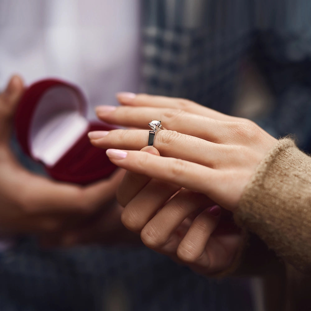 White gold diamond engagement ring wearing proposal to woman