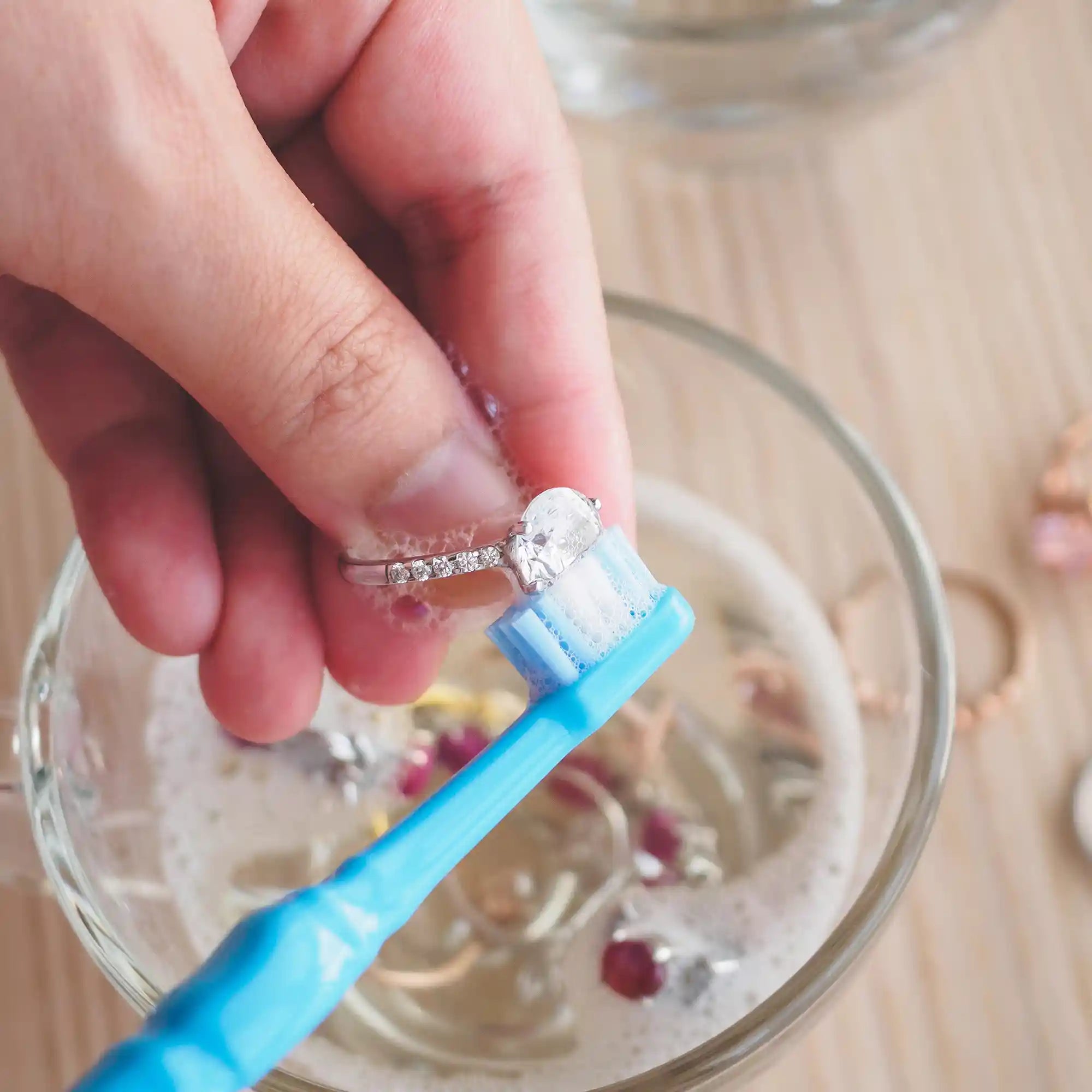 Cleaning a diamond gold ring from a soft brush scrubbing to gain natural appearance