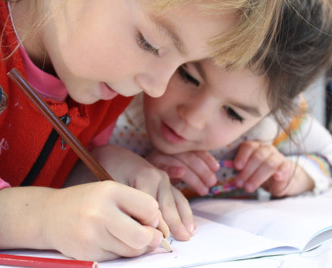 kids writing together 