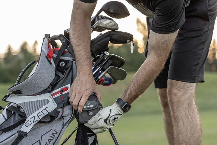 Golfer putting their Leupold Golf Rangefinder back in its carrying case.