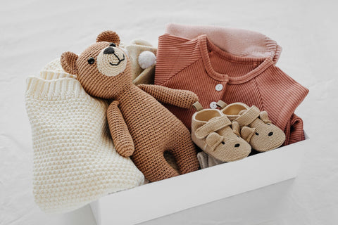 Box with teddy bear, sweater, gift card for Mom, baby shower gifts, and pregnancy items