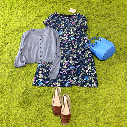 Dress with bright floral sleeves on a dark blue background