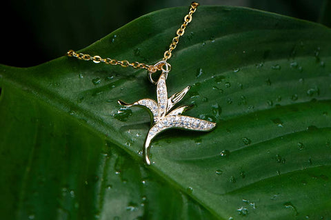 pave gold heliconia pendant lined with topaz