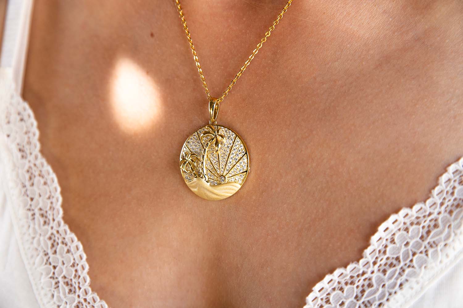 14K Gold vermeil medallion pendant with palm tree and sun rays lined with white topaz gemstones