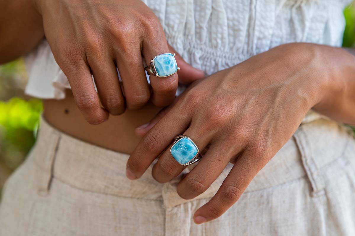 two larimar blue rings in classic cocktail design paired with white topaz gemstones