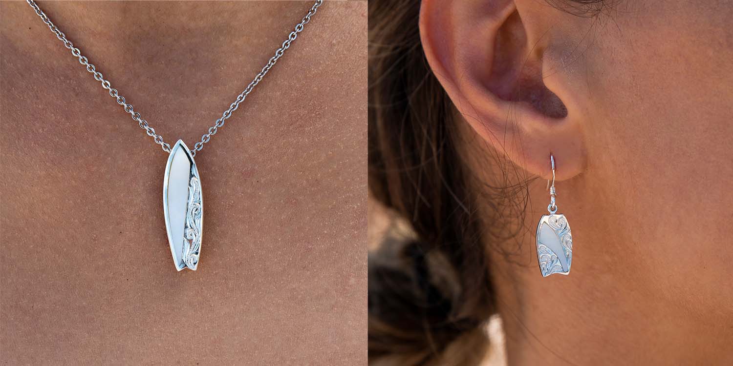 white mother of pearl surfboard jewelry set with pendant and earrings featuring traditional hand engraved Hawaiian scroll design