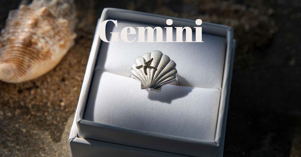 two-tone shell ring with a gold starfish on a silver matte shell