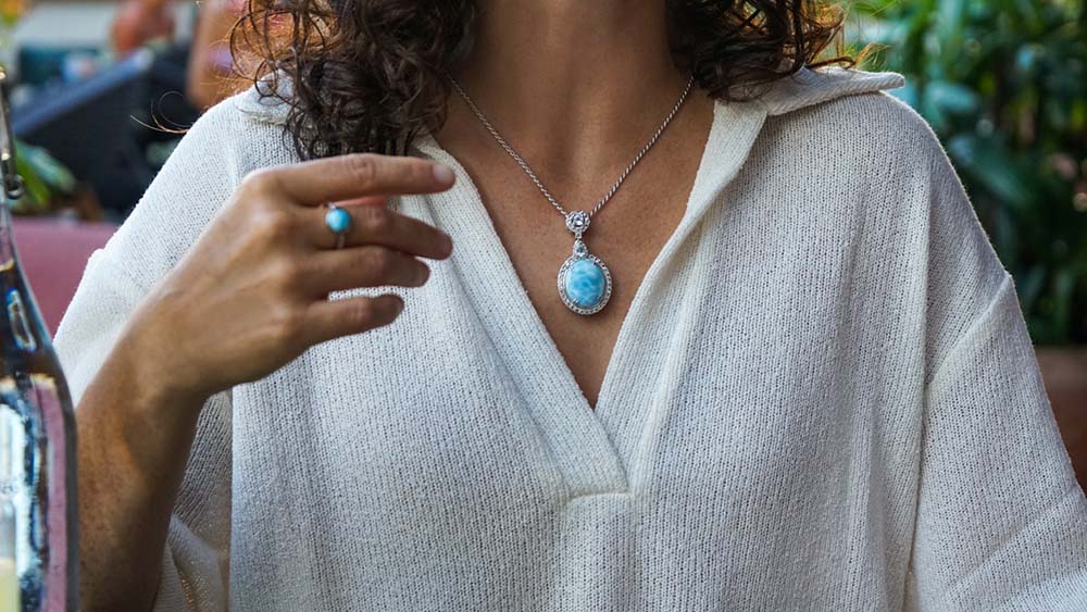 Larimar icy mirror pendant with white topaz worn by a model