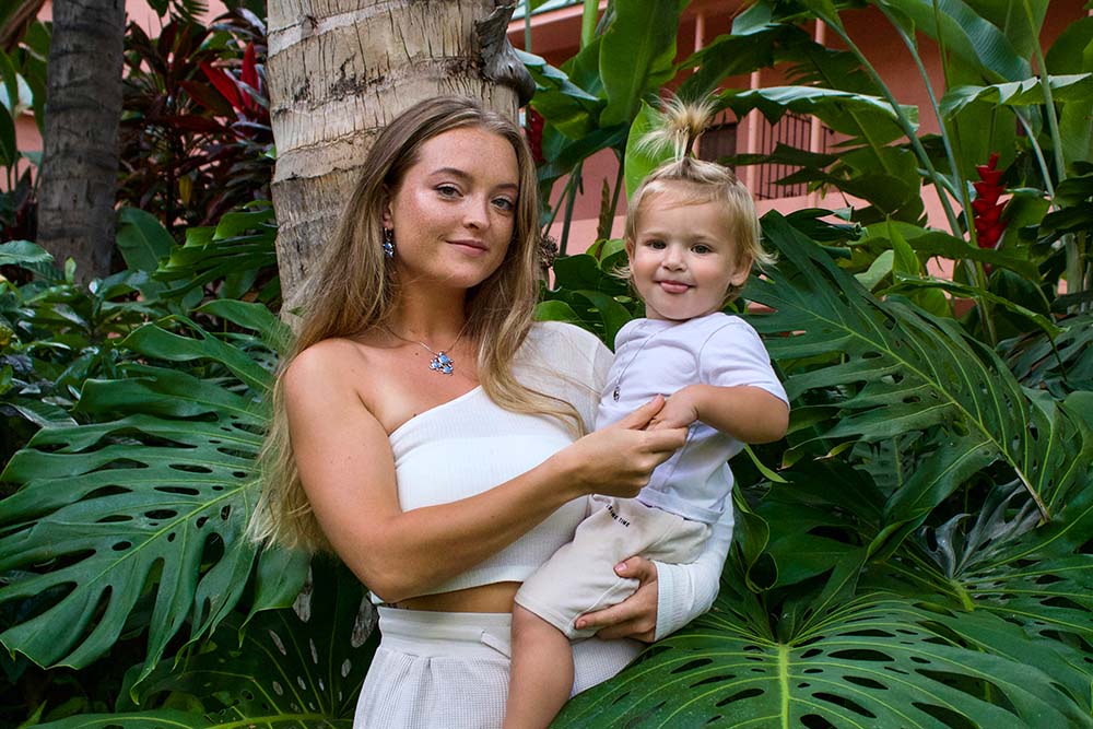 a young mother and child featuring a sustainable opal pendant called Ohana or family