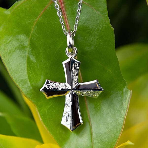 dark cocobolo wood cross with hand-engraved traditional Hawaiian scroll or wave detailing set in sterling silver