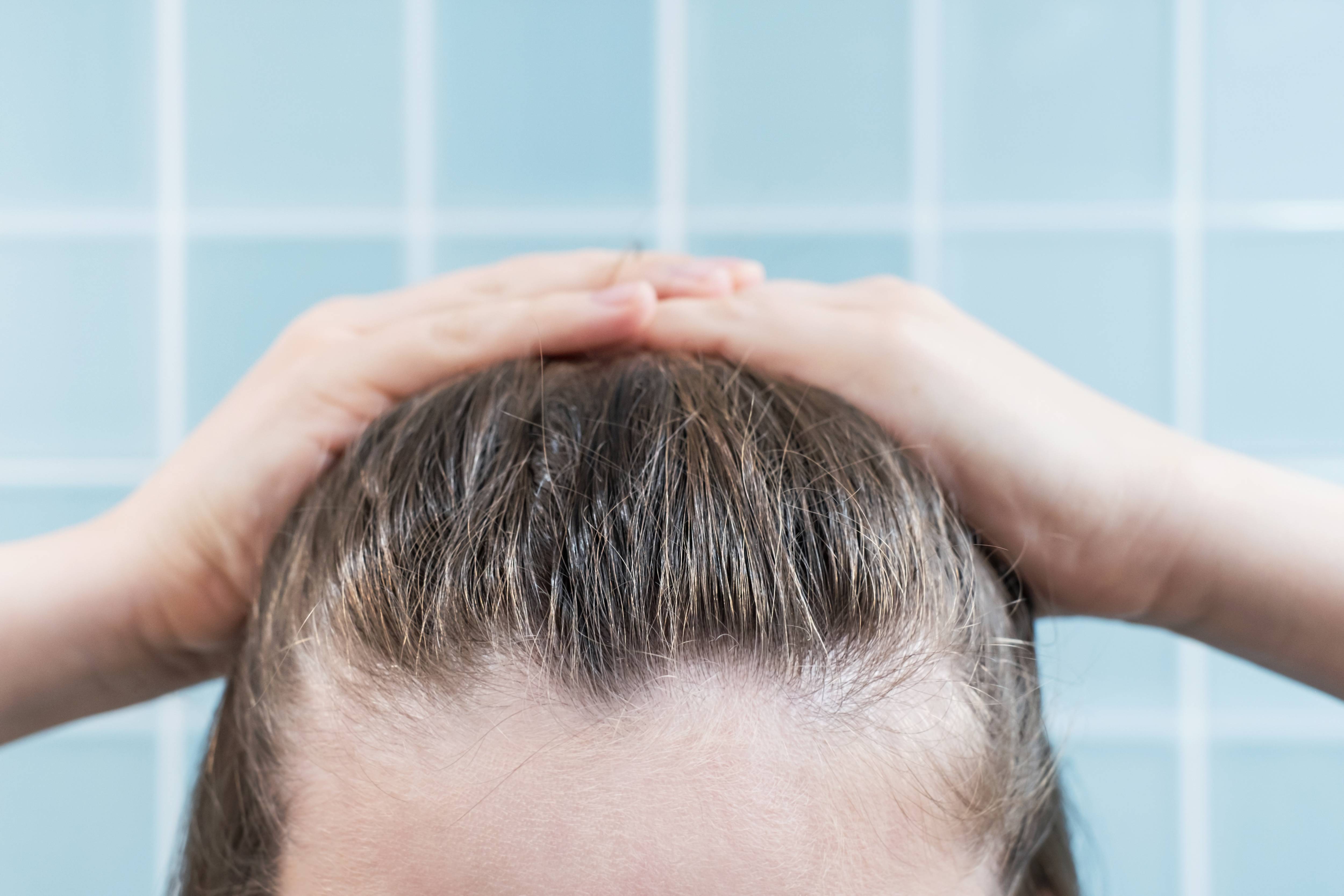 young-woman-touching-her-hair-close-up-on-blue-bac-2023-11-27-05-22-39-utc (1).jpg__PID:99eeef08-09bd-4146-a8d2-959766a9b4ab