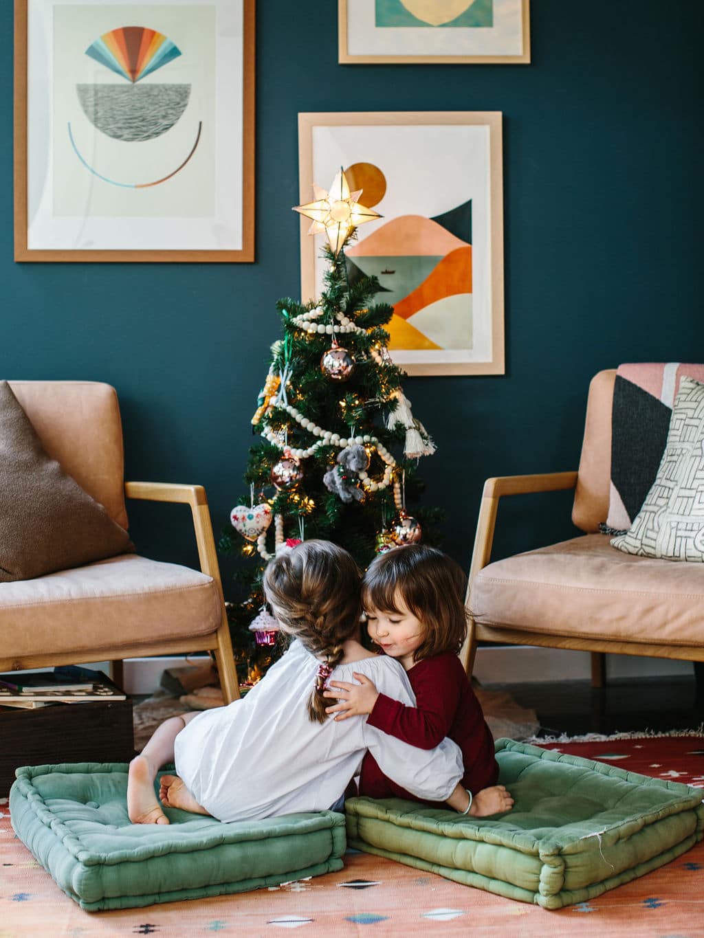 kids in pajamas around a christmas tree
