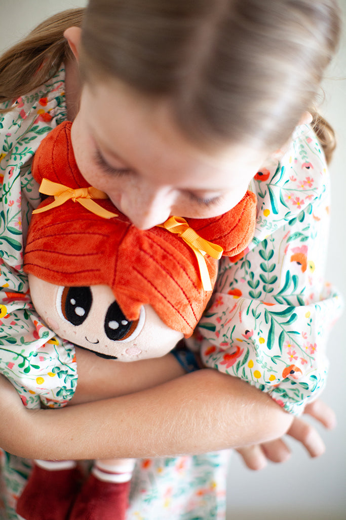 girl hugging stuffed doll