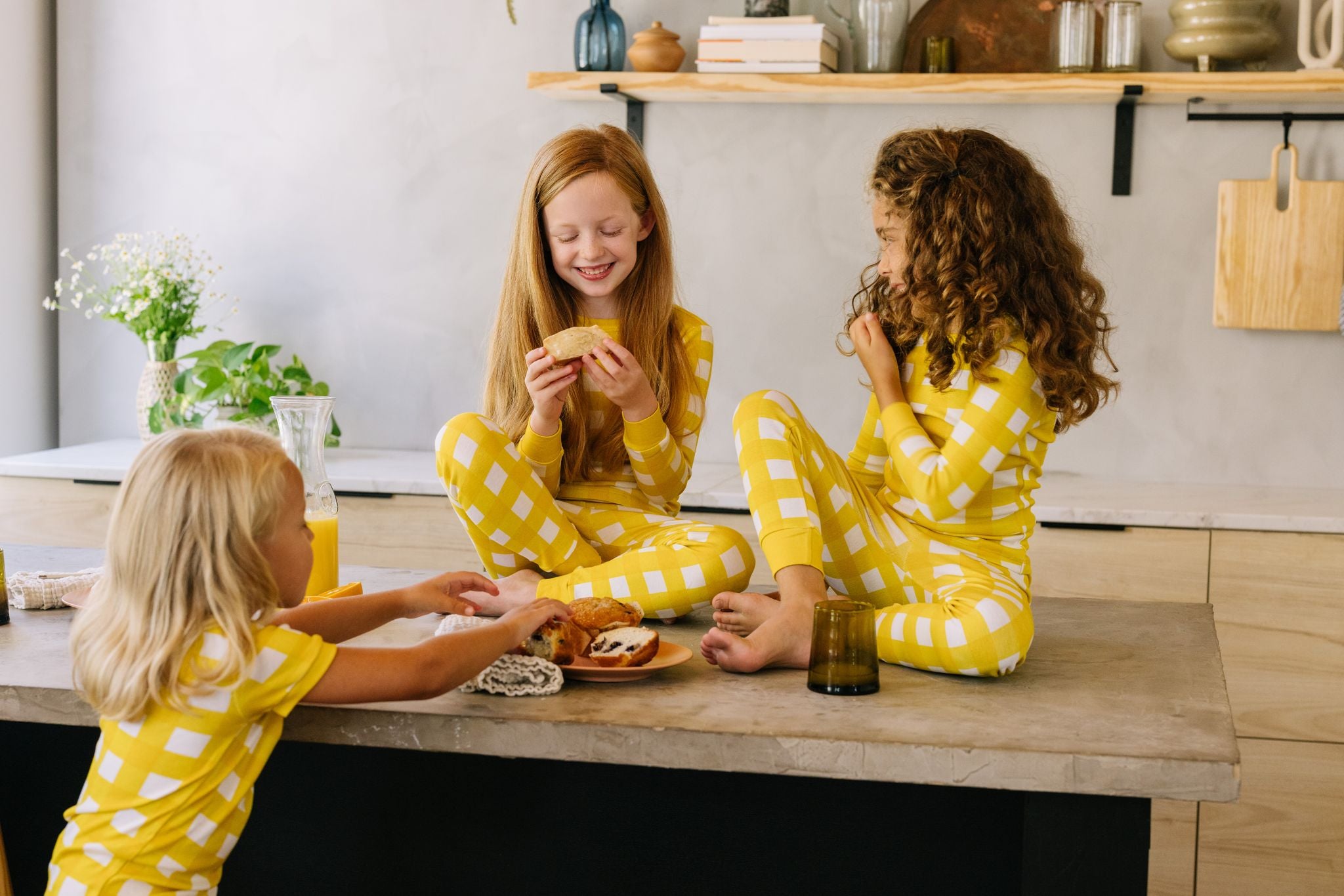 Kids Eating Breakfast in Yellow Gingham Pajama Sets with Pants and Long Sleeve Tops