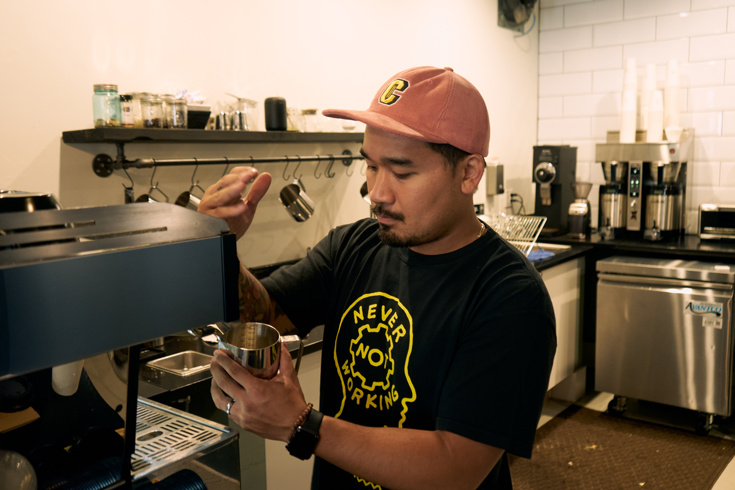 Francis Almeda owner of Side Project Coffee making an espresso drink