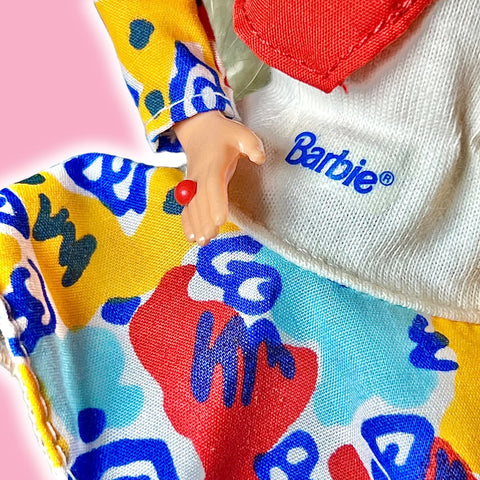 Closeup of the Barbie logo on Barbies shirt