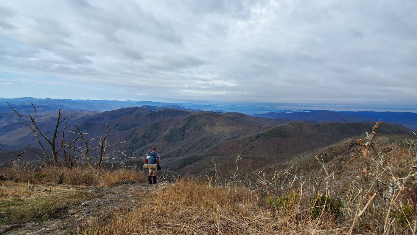 A man looks out at the mountains while hiking the Appalachian Trail