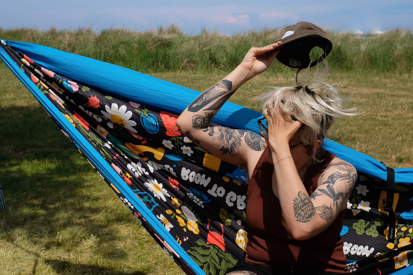 A person sits in an ENO DoubleNest Hammock Print while near the lake in Chicago