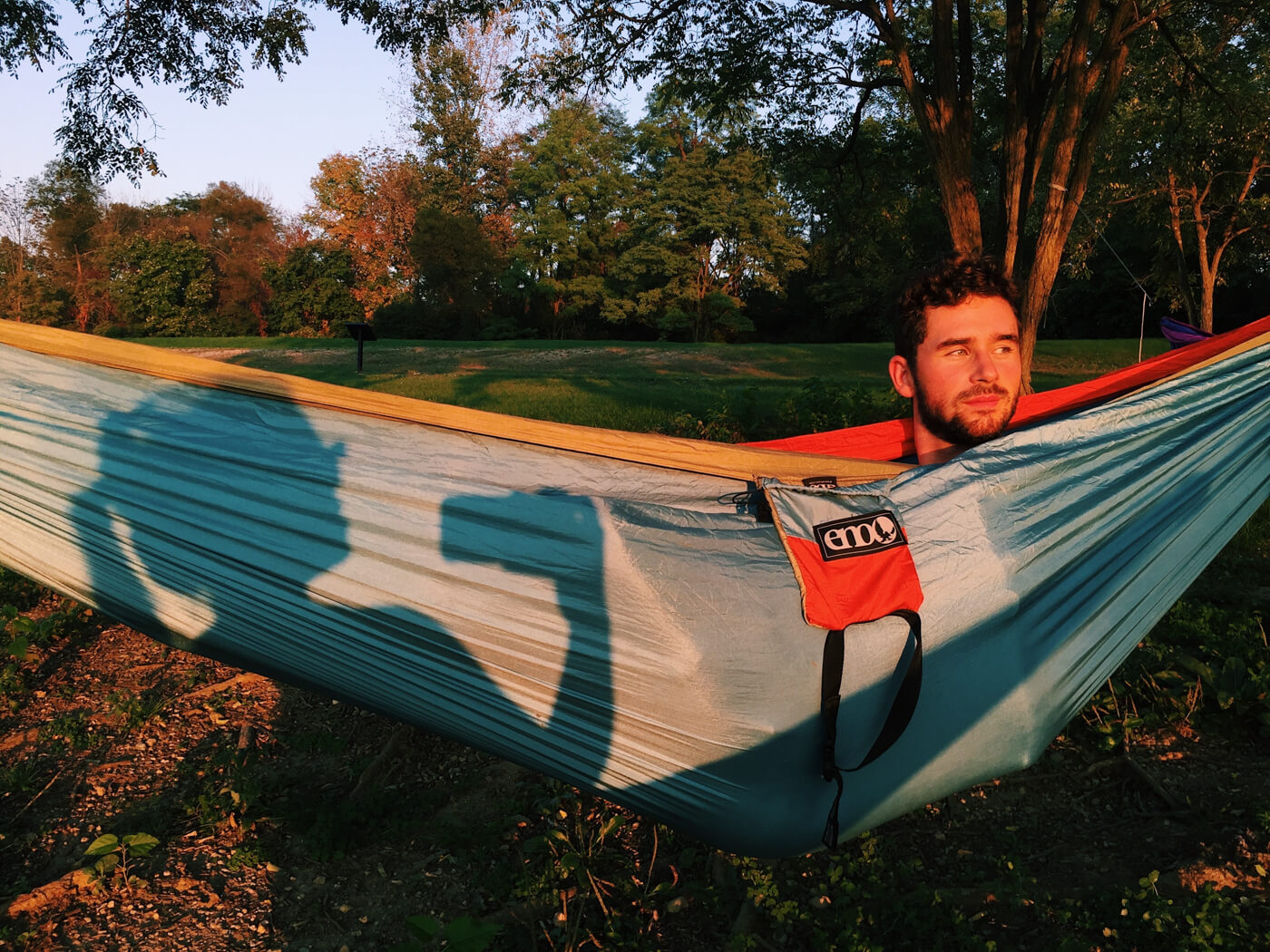 An image of a brother and sister hammocking together.