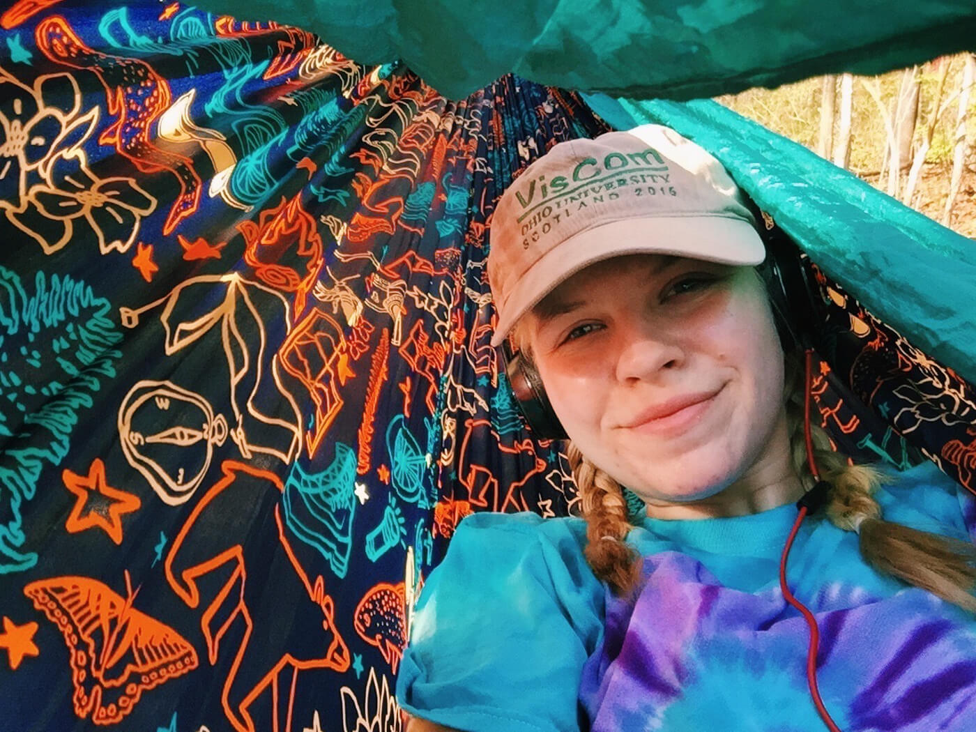 ENO Digital Content Producer poses for a photo while laying in her ENO DoubleNest Hammock Print