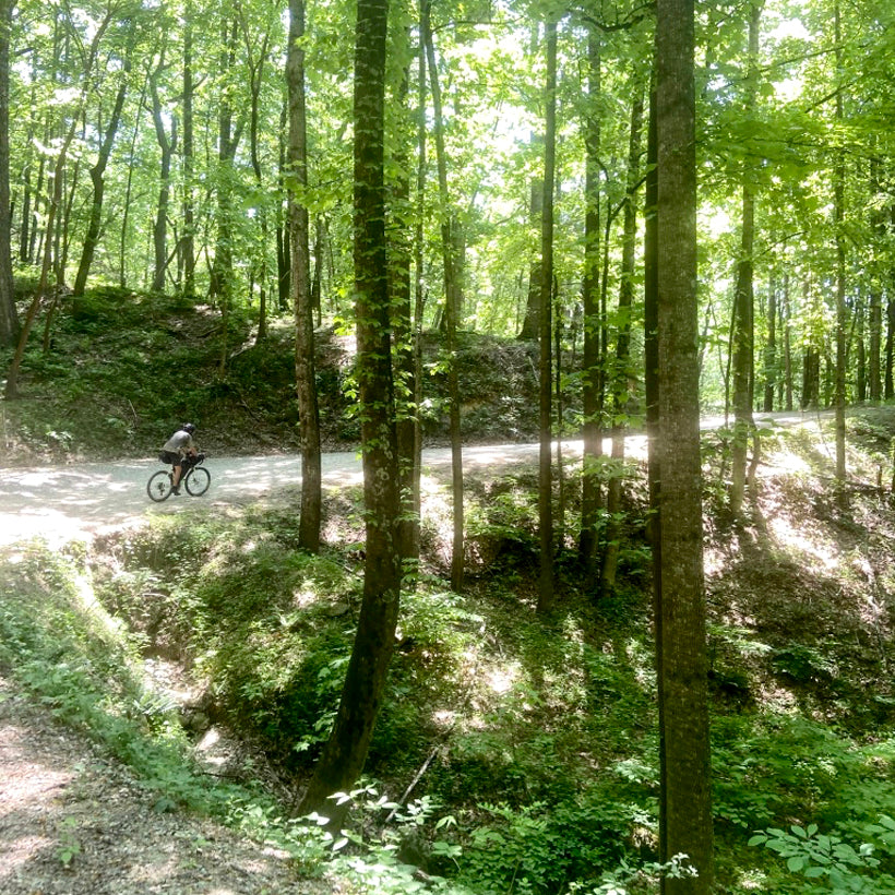 A man rides his bike on a gravel road during the Wilson's Ramble Bikepacking race.