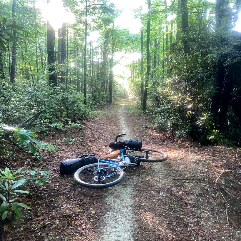A bike lays across a dirt path during the Wilson's Ramble Bikepacking race.