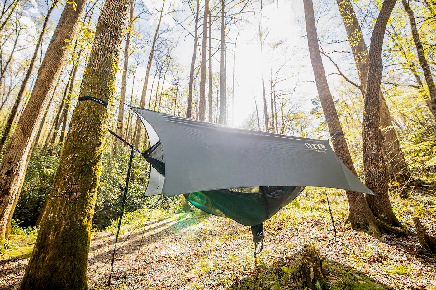 A OneLink hammock camping system is fully setup in the woods and ready for hammock camping.