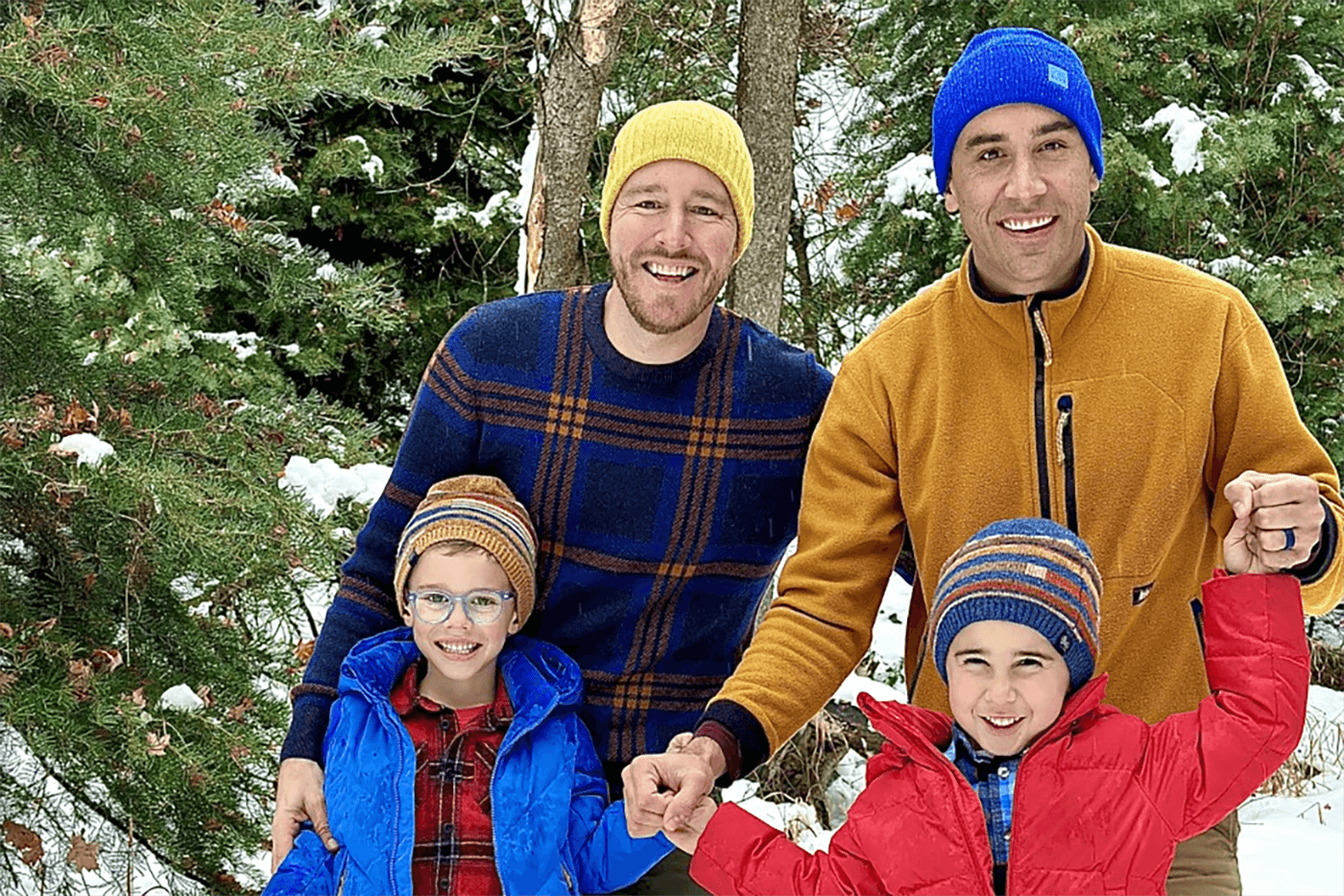 A family of four poses for a picture during the winter. 