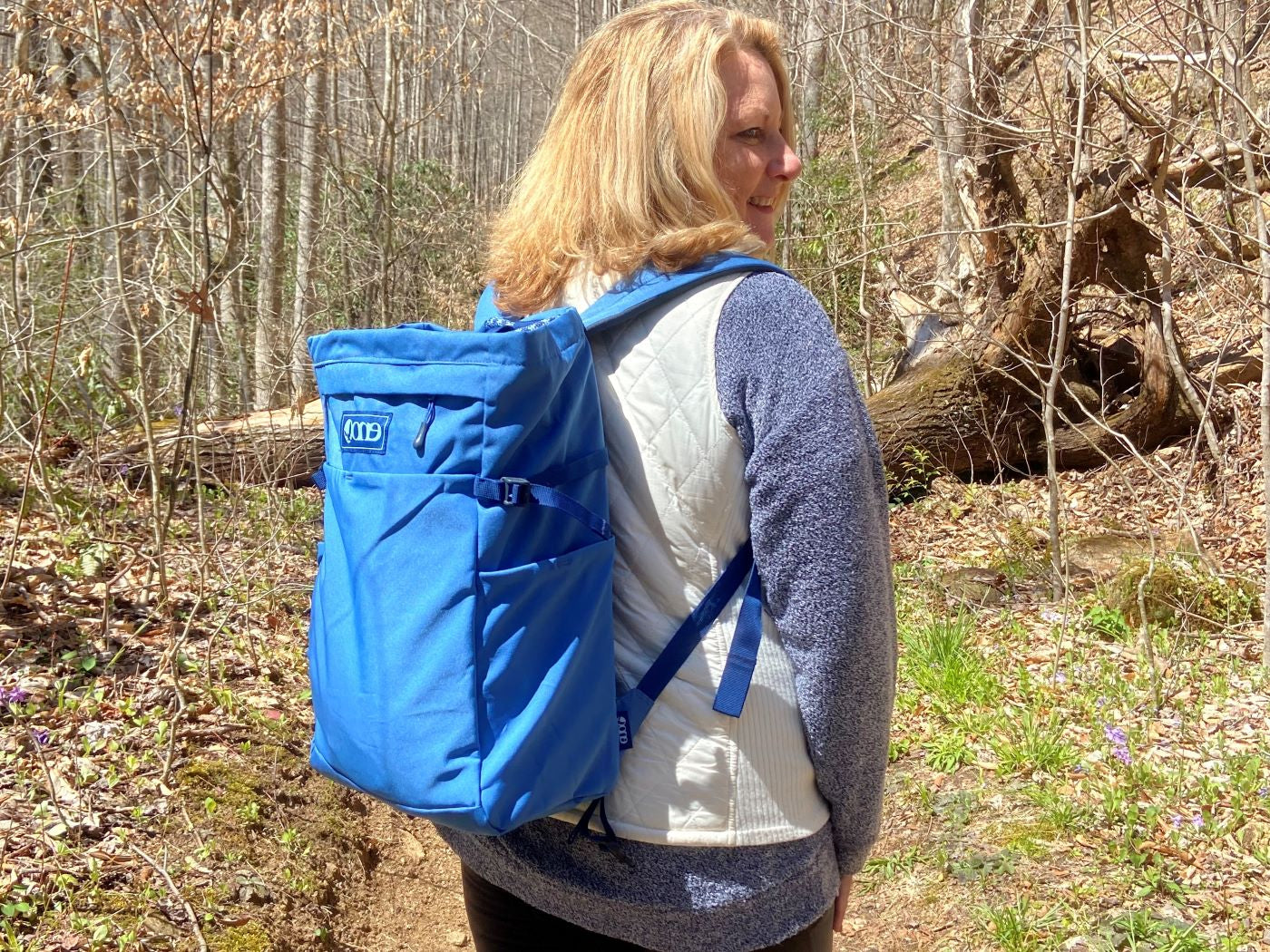 Woman carrying an ENO Roan TotePack in WNC woods. 