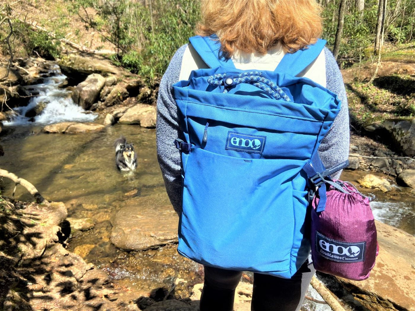 Woman carrying ENO Roan TotePack and ENO DoubleNest Hammock in WNC woods. 