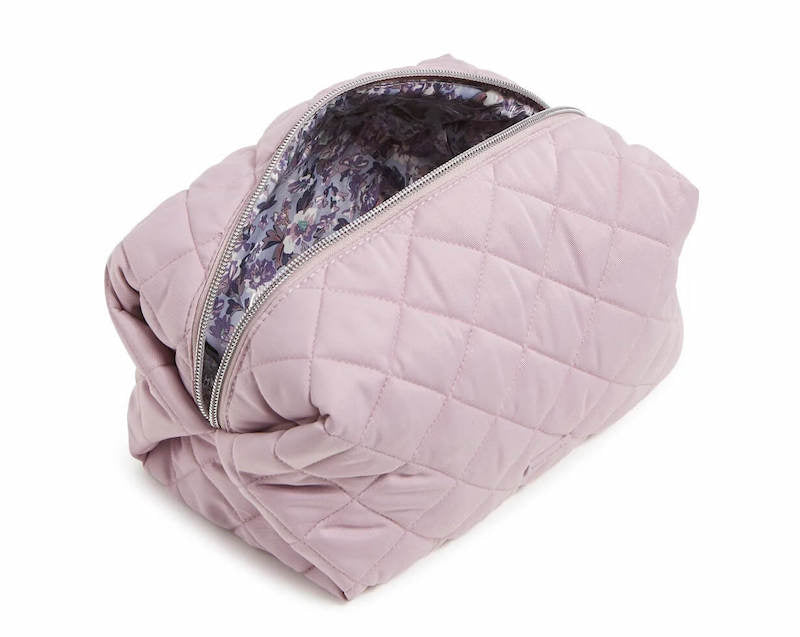 large light pink quilted cosmetic bag open to show space inside
