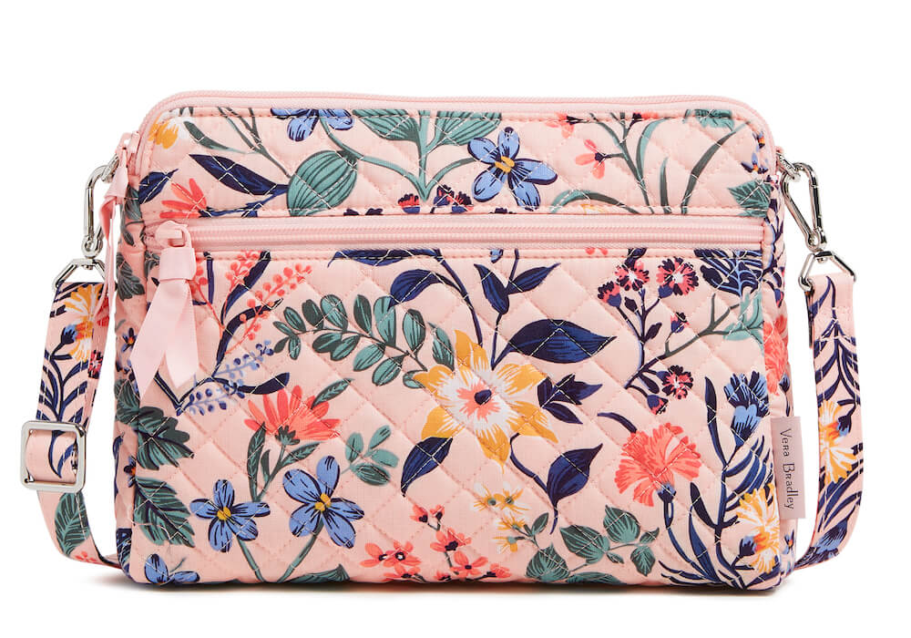 Pink crossbody bag with vibrant floral pattern