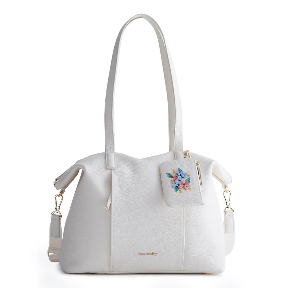 White leather tote bag with small floral zip wallet