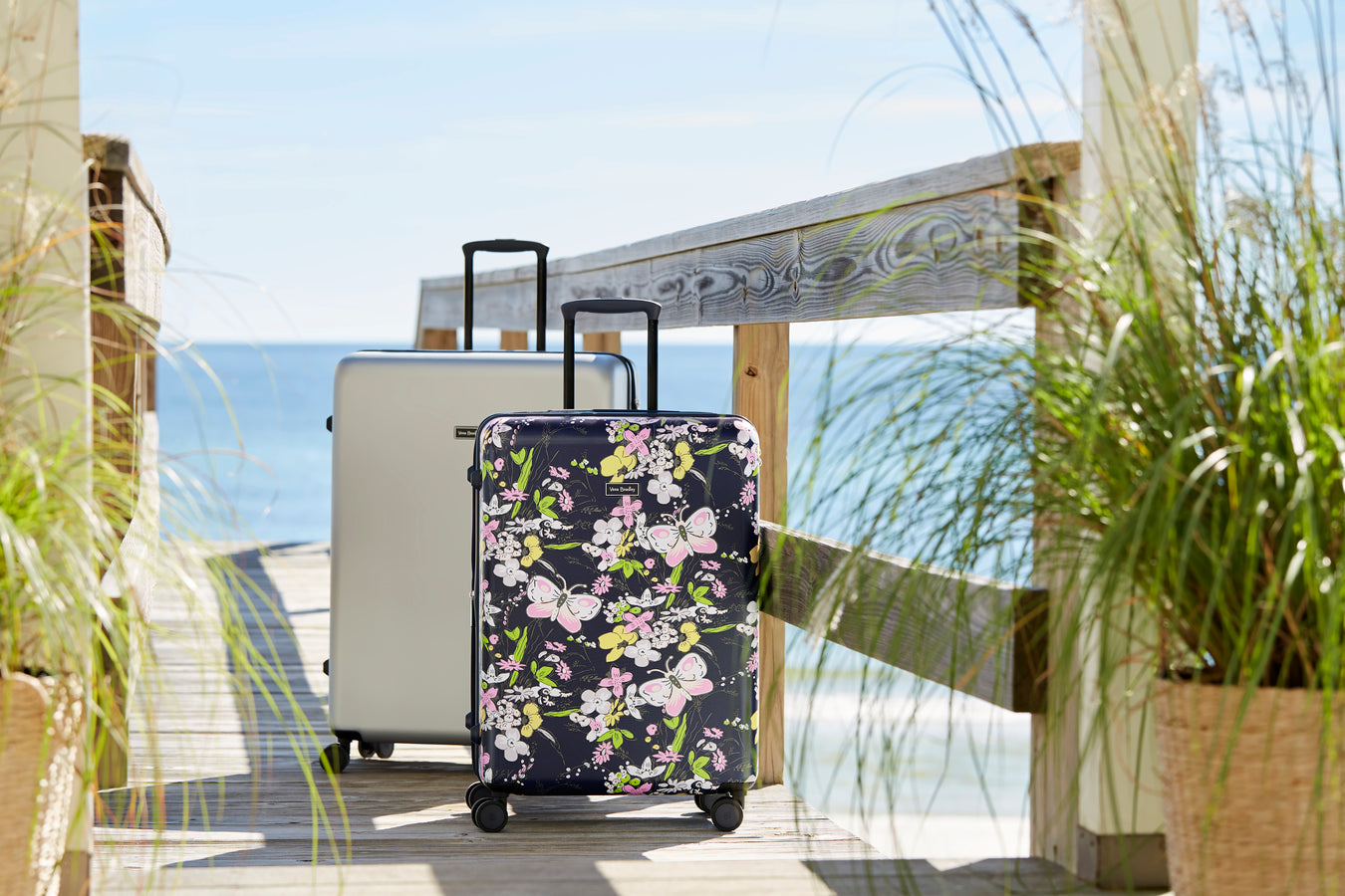 Two pieces of luggage on boardwalk