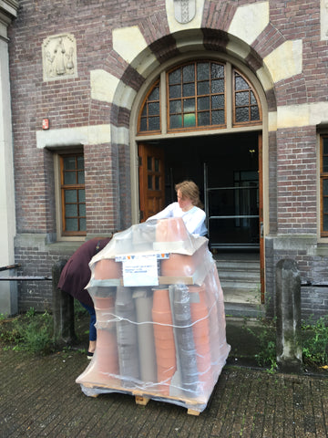 Pallet met terracotta wordt Prinsengrachtgebouw binnengebracht